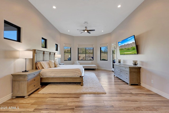 bedroom with ceiling fan and light hardwood / wood-style floors