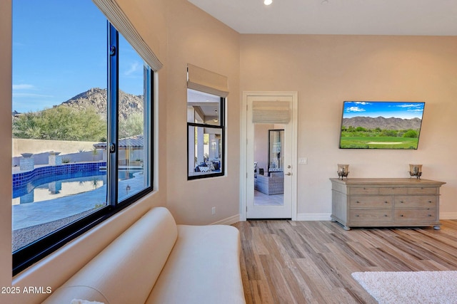 interior space with light wood-type flooring and a mountain view