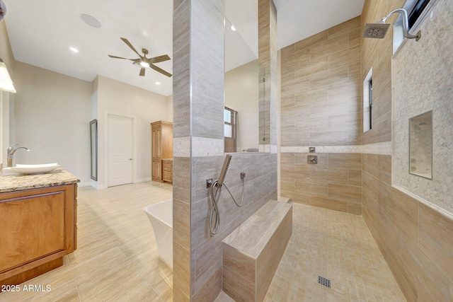 bathroom featuring tile patterned floors, ceiling fan, separate shower and tub, and vanity