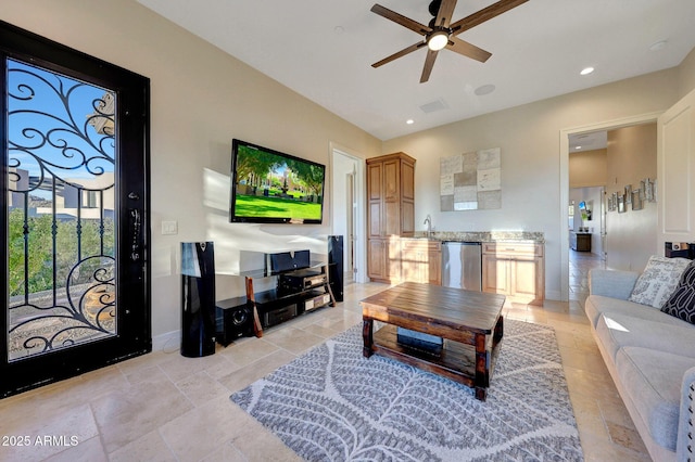 living room featuring ceiling fan and sink