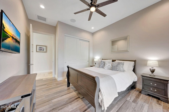 bedroom with a closet, ceiling fan, and light hardwood / wood-style floors