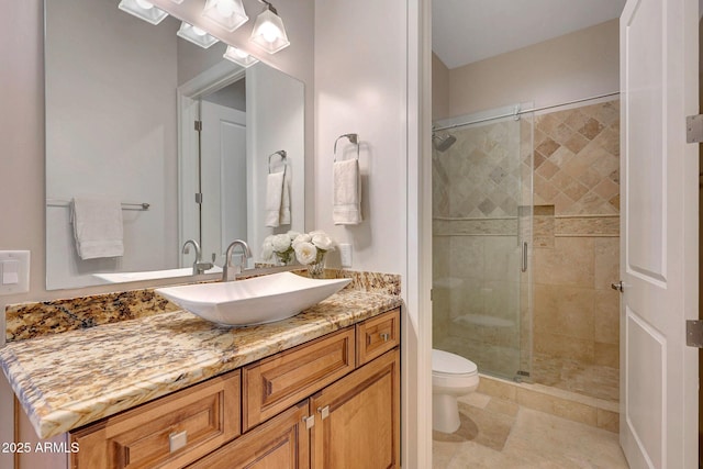 bathroom featuring toilet, an enclosed shower, and vanity