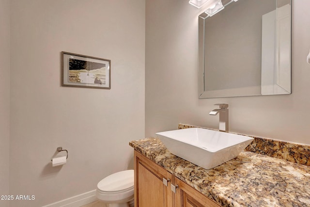 bathroom featuring toilet and vanity