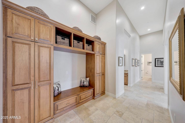 mudroom featuring a high ceiling