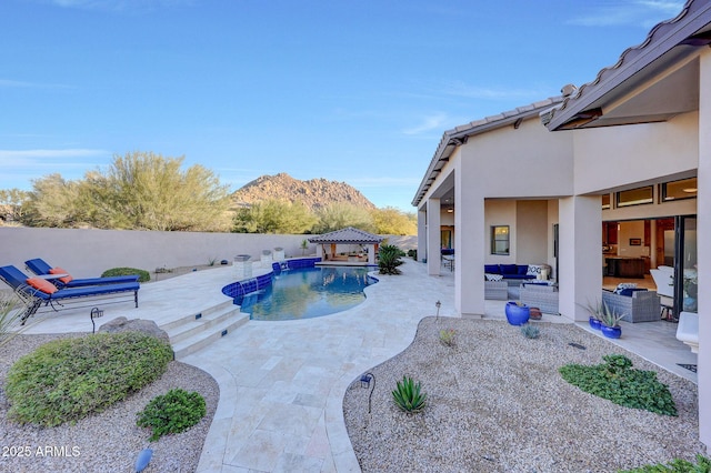 view of swimming pool with a patio, a gazebo, an outdoor hangout area, and a mountain view