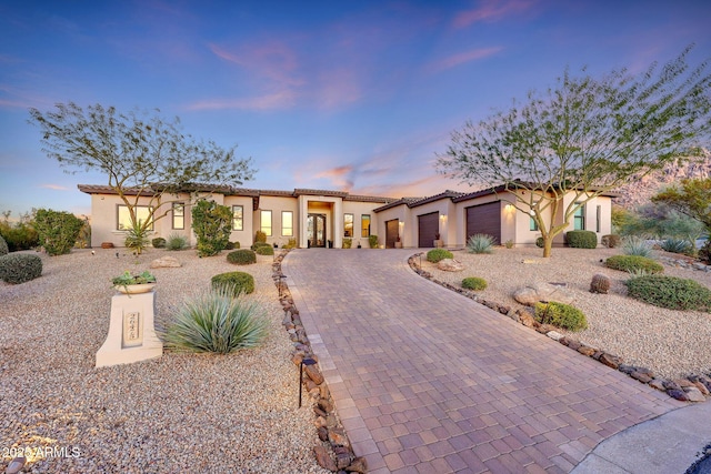 mediterranean / spanish-style house with a garage