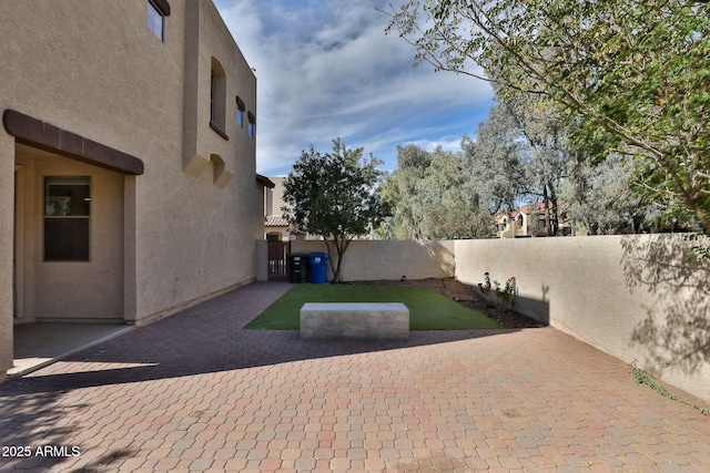 view of yard featuring a patio area and a fenced backyard