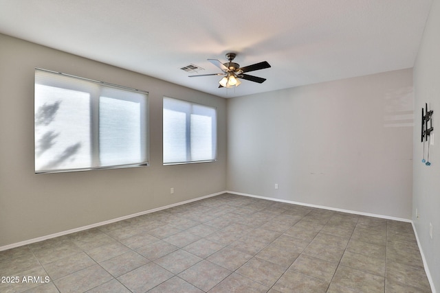 unfurnished room with visible vents, ceiling fan, baseboards, and light tile patterned flooring