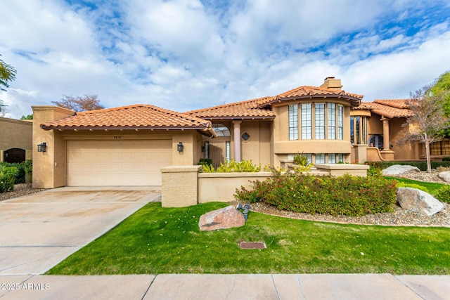 mediterranean / spanish-style house featuring a garage and a front lawn