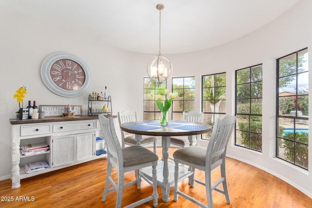 dining room with an inviting chandelier and light hardwood / wood-style flooring