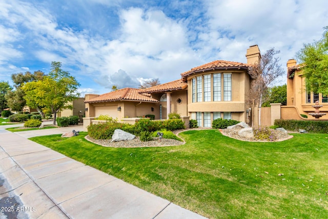 mediterranean / spanish-style home with a front lawn and a garage