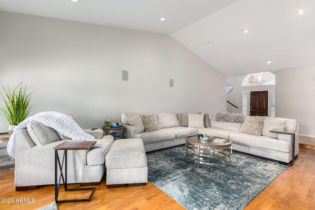 living room featuring light hardwood / wood-style flooring and vaulted ceiling