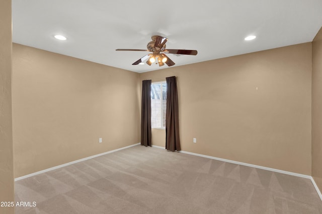 empty room featuring baseboards, recessed lighting, and light colored carpet