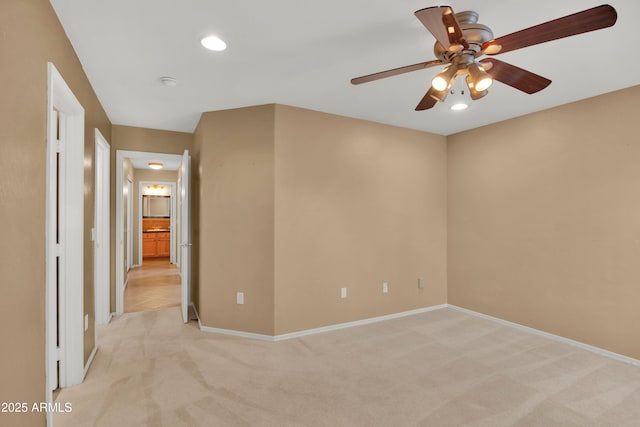 spare room with light colored carpet and baseboards