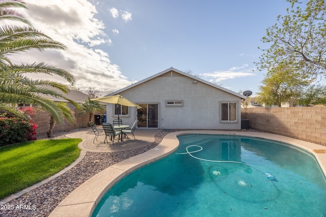 view of swimming pool featuring a patio, central AC, and a fenced backyard