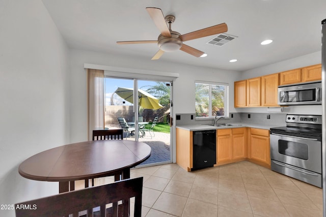 kitchen featuring light countertops, visible vents, light brown cabinetry, appliances with stainless steel finishes, and light tile patterned flooring