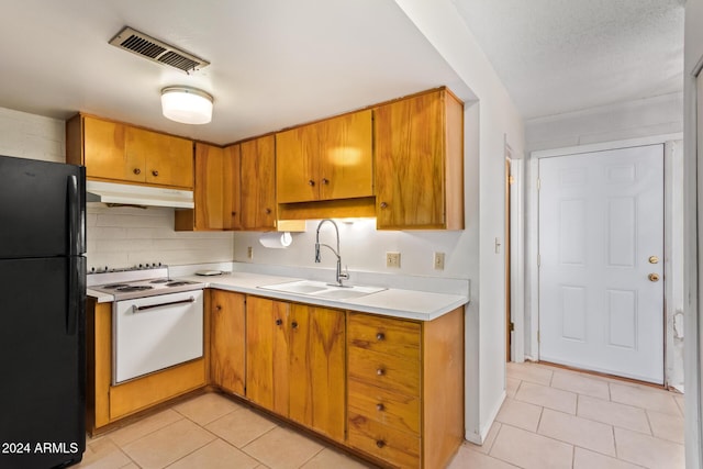 kitchen with black refrigerator, light tile patterned floors, white electric stove, and sink