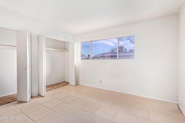 unfurnished bedroom featuring two closets