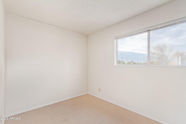 empty room featuring a textured ceiling