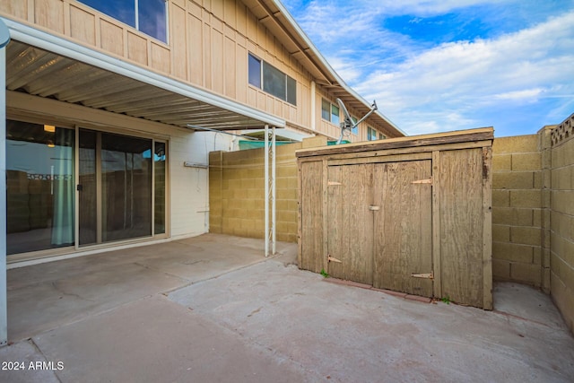 view of patio / terrace featuring a storage unit