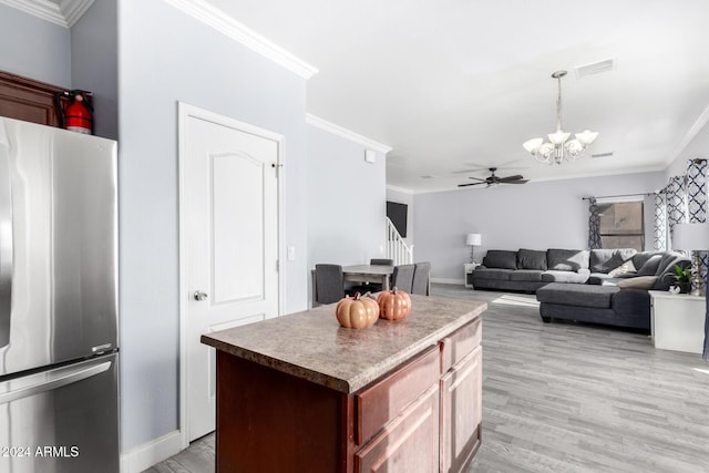 kitchen featuring light wood-type flooring, ceiling fan with notable chandelier, crown molding, a center island, and stainless steel refrigerator