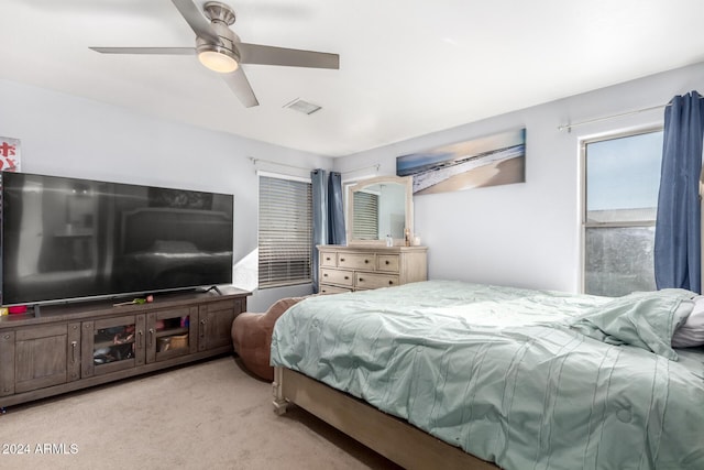 bedroom with light colored carpet and ceiling fan