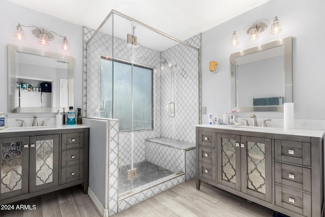 bathroom featuring vanity, an enclosed shower, and wood-type flooring