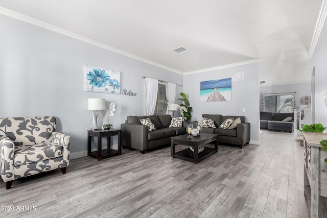 living room featuring light hardwood / wood-style floors and crown molding