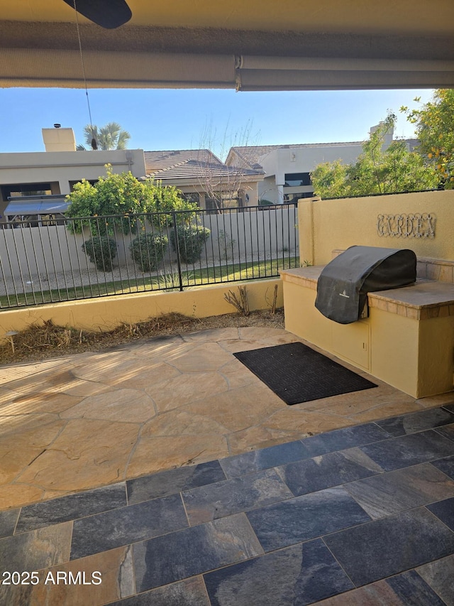 view of patio / terrace with grilling area, ceiling fan, and exterior kitchen