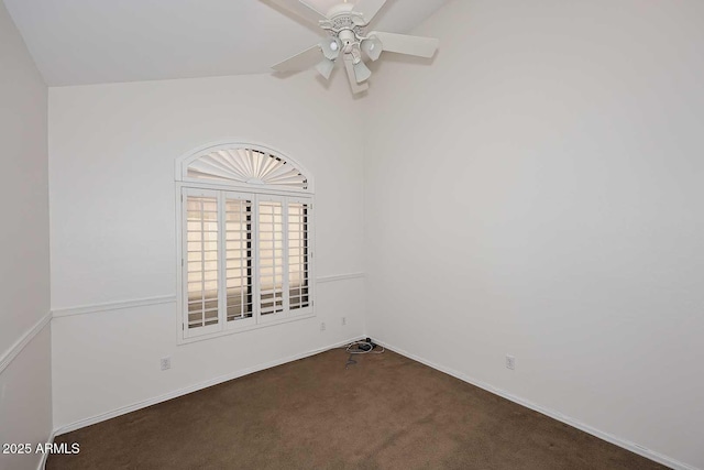 spare room featuring ceiling fan, lofted ceiling, and dark carpet