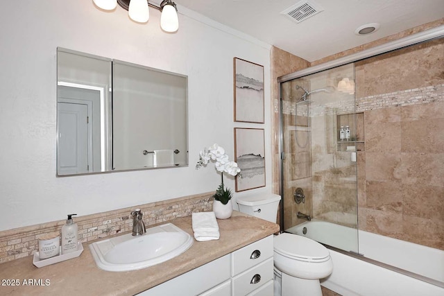 full bathroom with vanity, decorative backsplash, shower / bath combination with glass door, and toilet