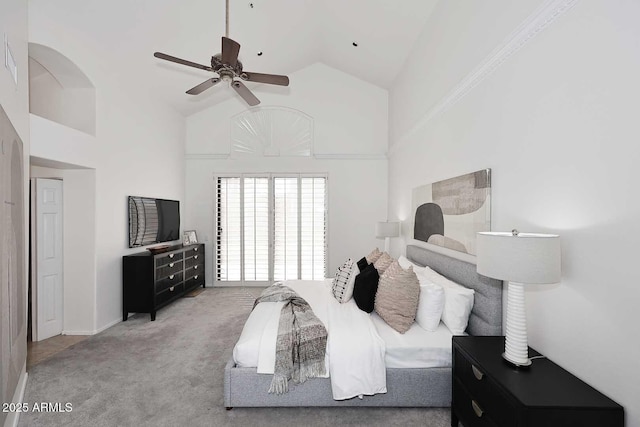 bedroom with high vaulted ceiling, ceiling fan, and carpet