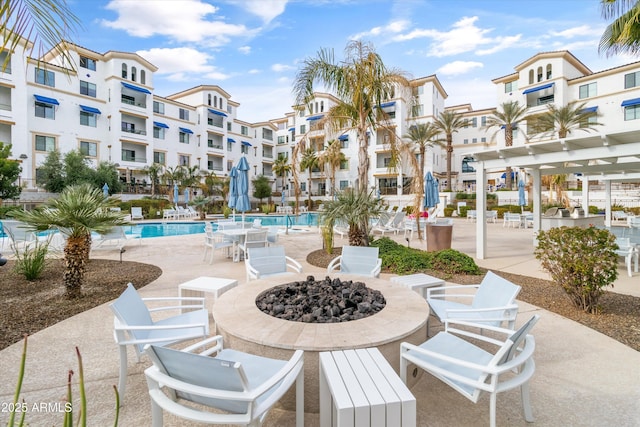 view of patio featuring a fire pit and a community pool