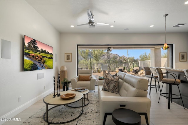 living room with recessed lighting, baseboards, light wood finished floors, visible vents, and ceiling fan