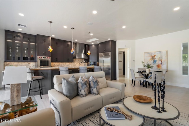 living area with light tile patterned floors, recessed lighting, baseboards, and visible vents