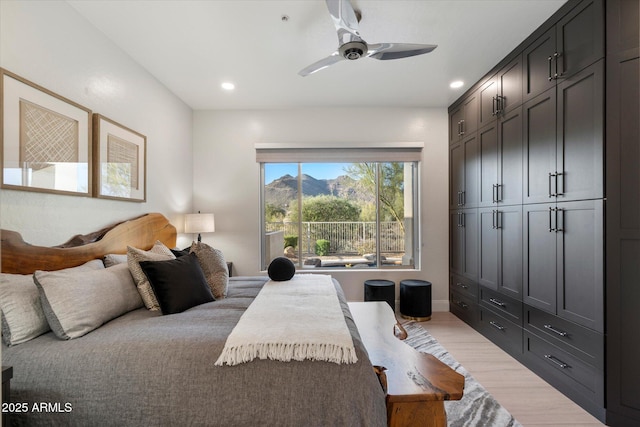 bedroom with light wood finished floors, ceiling fan, and recessed lighting