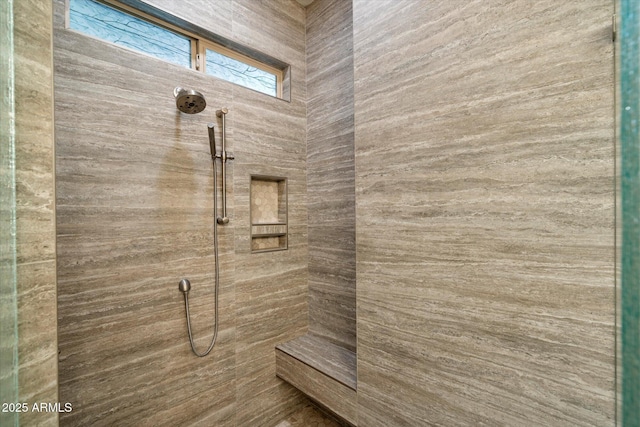 full bathroom featuring tiled shower