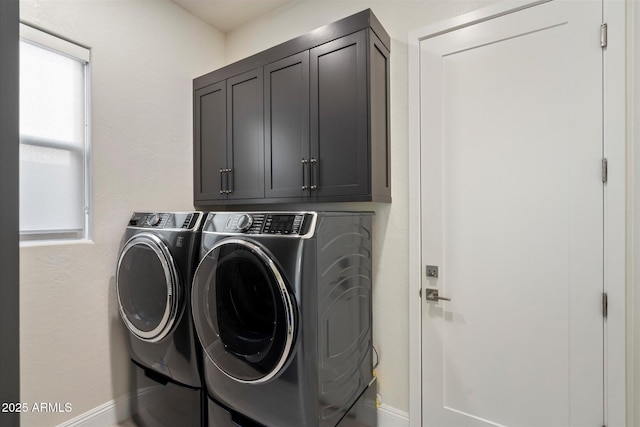 washroom featuring cabinet space and washer and dryer