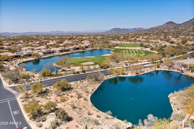 birds eye view of property with a water and mountain view