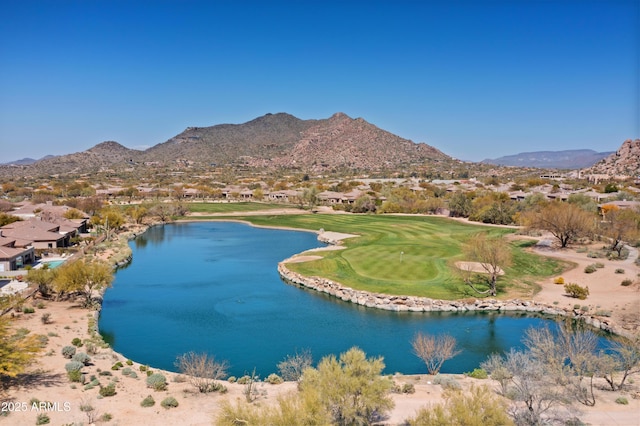 drone / aerial view with view of golf course and a water and mountain view