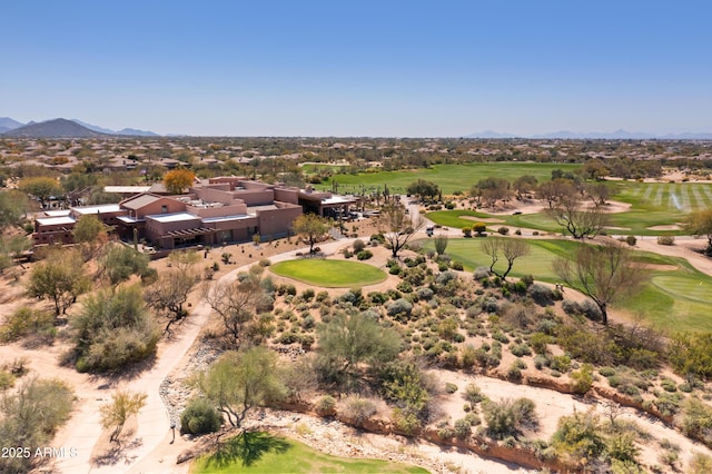 drone / aerial view featuring golf course view and a mountain view
