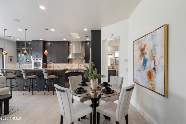 dining room with baseboards and recessed lighting