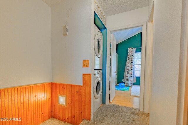 8111 W Wacker Rd Unit 62, Peoria, AZ 85381 - laundry room with stacked washer / drying machine, wainscoting, carpet, a textured ceiling, and wooden walls