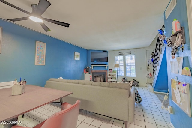 8111 W Wacker Rd Unit 62, Peoria, AZ 85381 - living room with a brick fireplace, ceiling fan, and light tile patterned floors