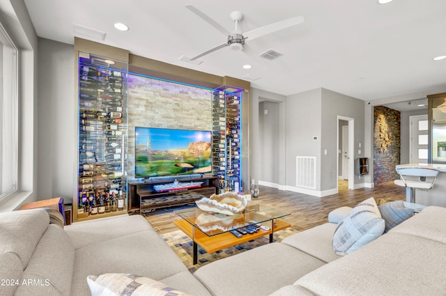 living room featuring light hardwood / wood-style flooring and ceiling fan