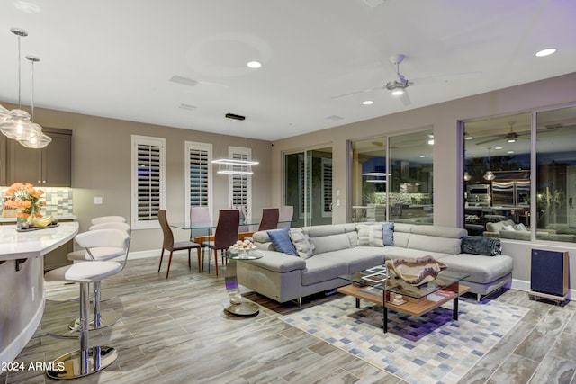 living room featuring a ceiling fan, wood tiled floor, baseboards, and recessed lighting