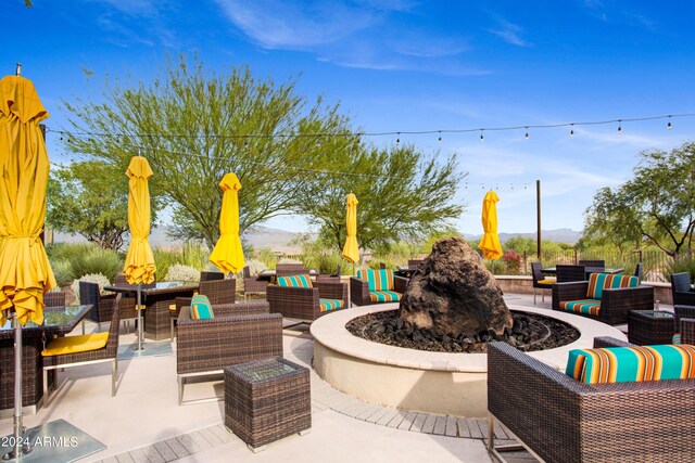 view of patio featuring an outdoor living space with a fire pit