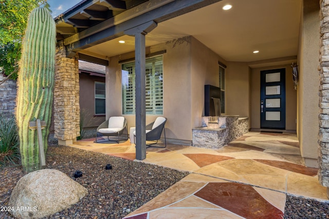 entrance to property with a patio area and stucco siding