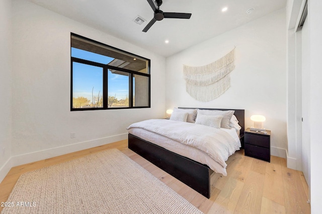 bedroom with ceiling fan and light hardwood / wood-style floors