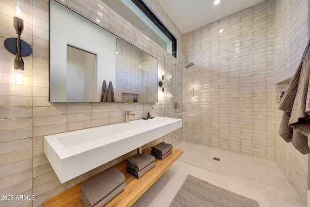 bathroom with tile patterned flooring, a shower, and tile walls